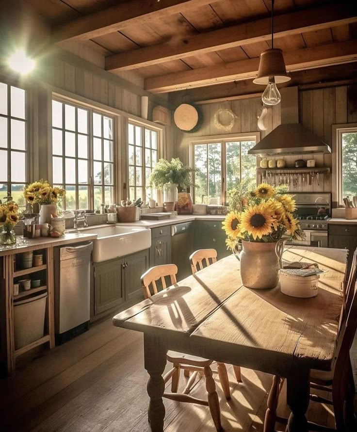 sunflowers are in a vase on the kitchen table next to an oven and sink