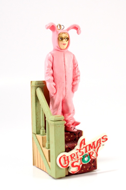 a figurine wearing a pink bunny suit standing on top of a set of stairs