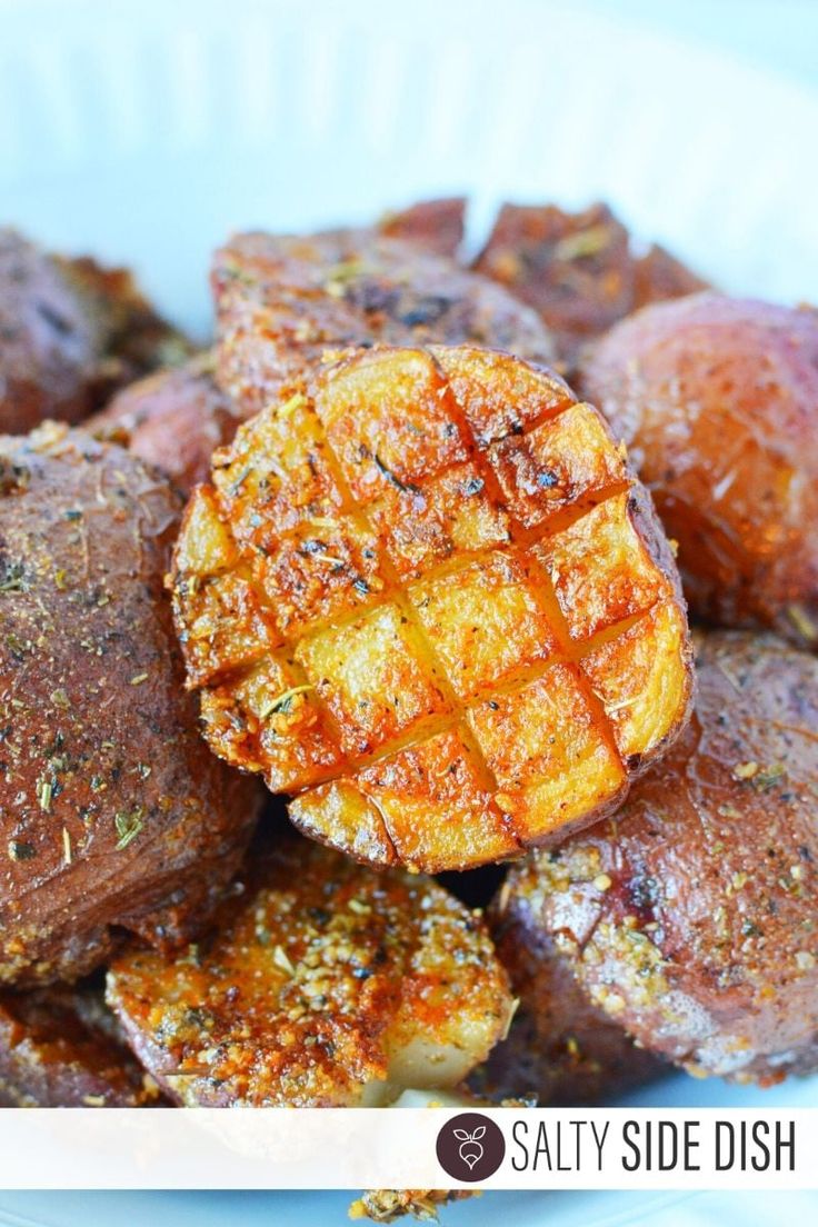 a white plate topped with potatoes covered in seasoning