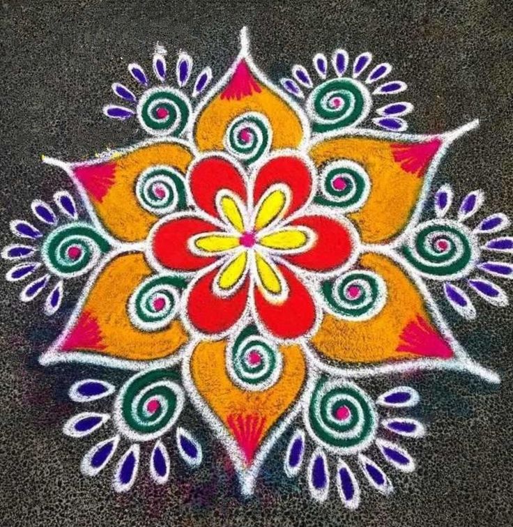 a colorful flower design is painted on the ground