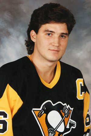 this is an image of a young man in hockey uniform posing for a portrait photo