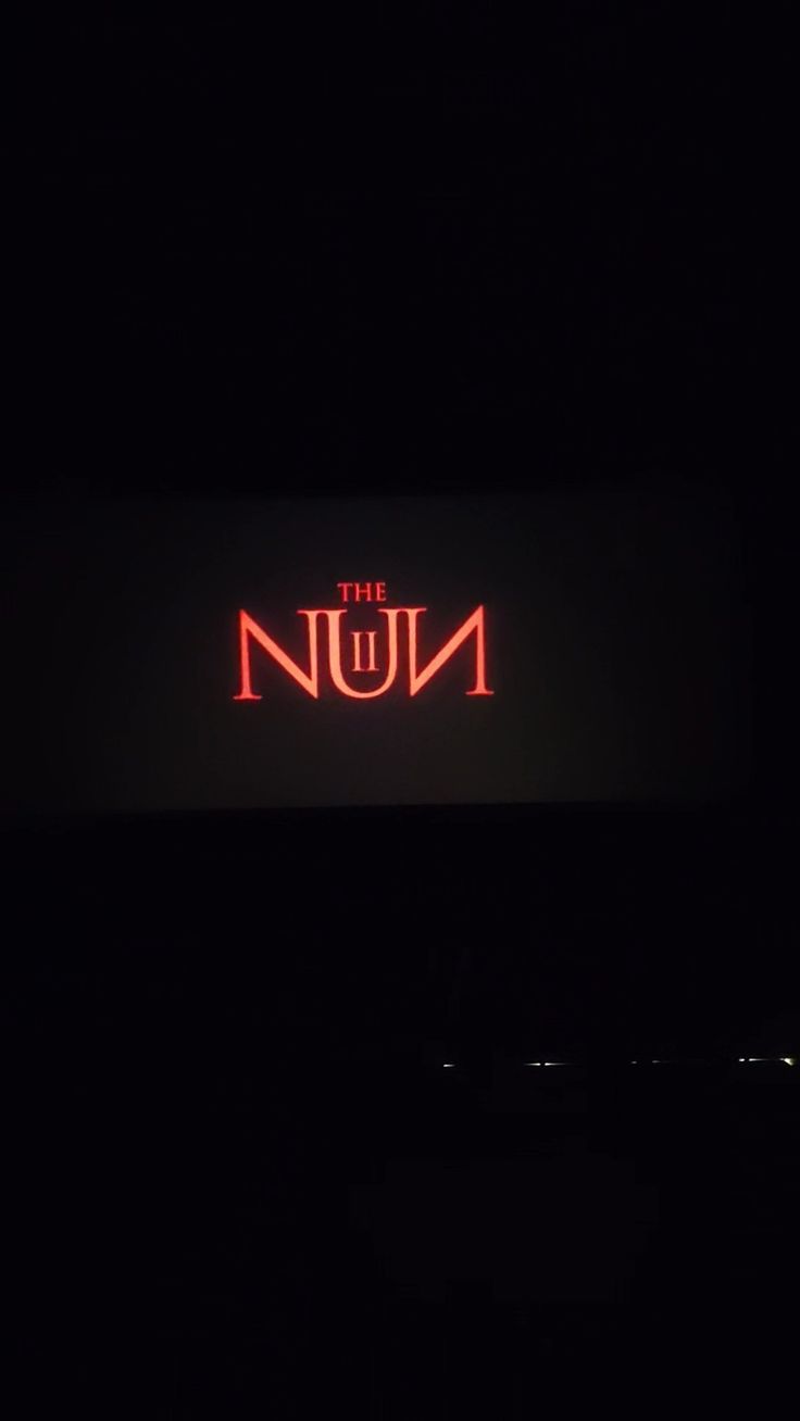 the num neon sign lit up in the dark with no one around it at night