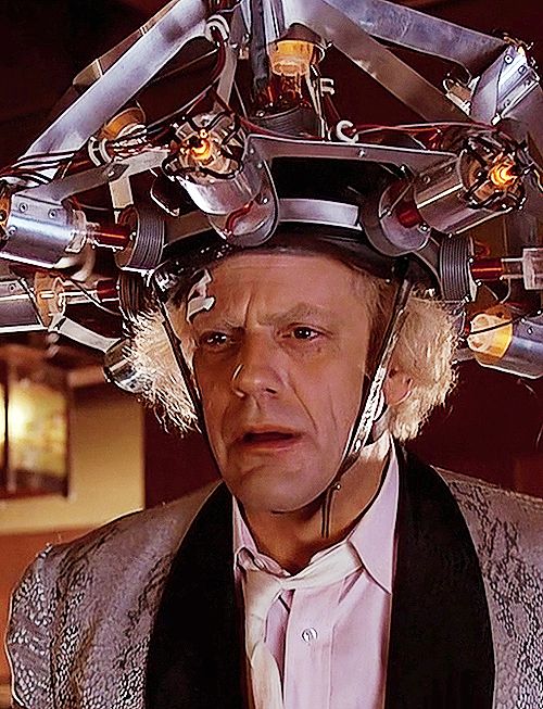 a man in a suit and tie with lots of wires on his head