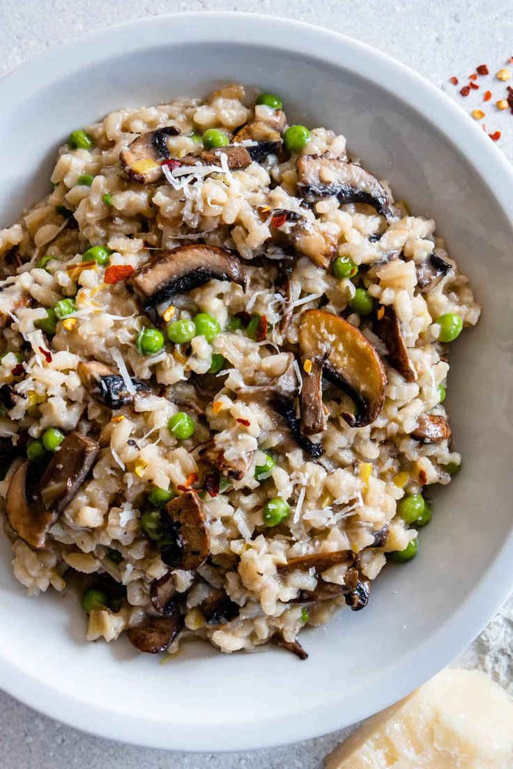 a white bowl filled with rice and mushrooms