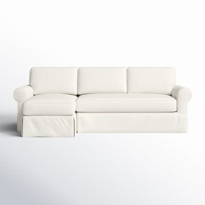 a white couch sitting on top of a white floor