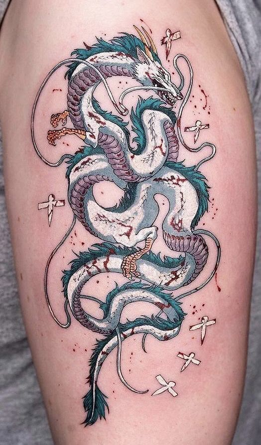 a dragon tattoo on the back of a woman's left arm, with stars around it