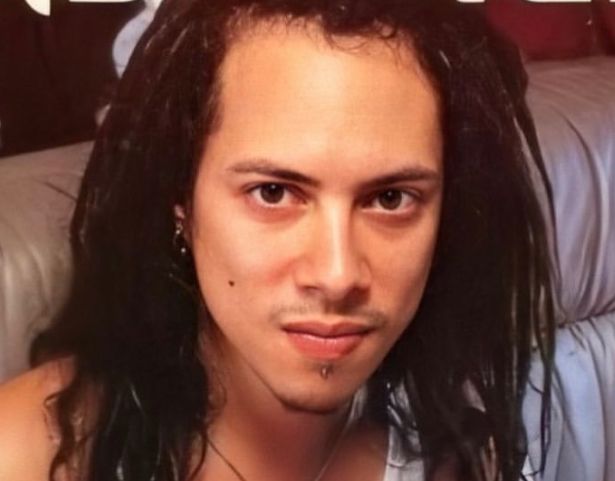 a man with dreadlocks on his head is posing for a photo in front of a magazine cover