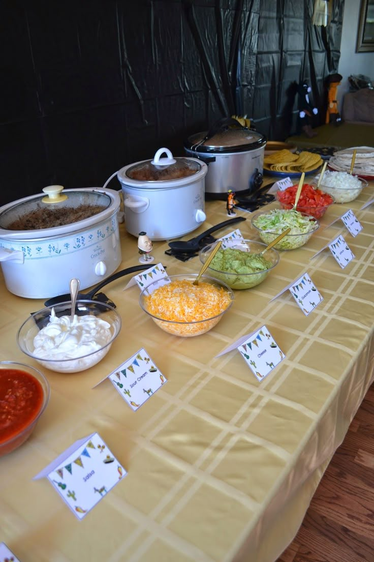 a table topped with lots of different types of food and bowls filled with sauces