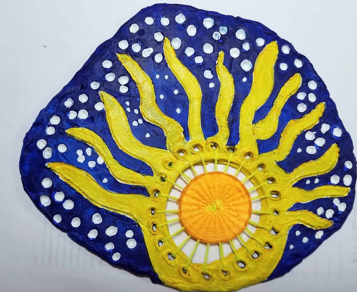 a blue and yellow painted object with white dots