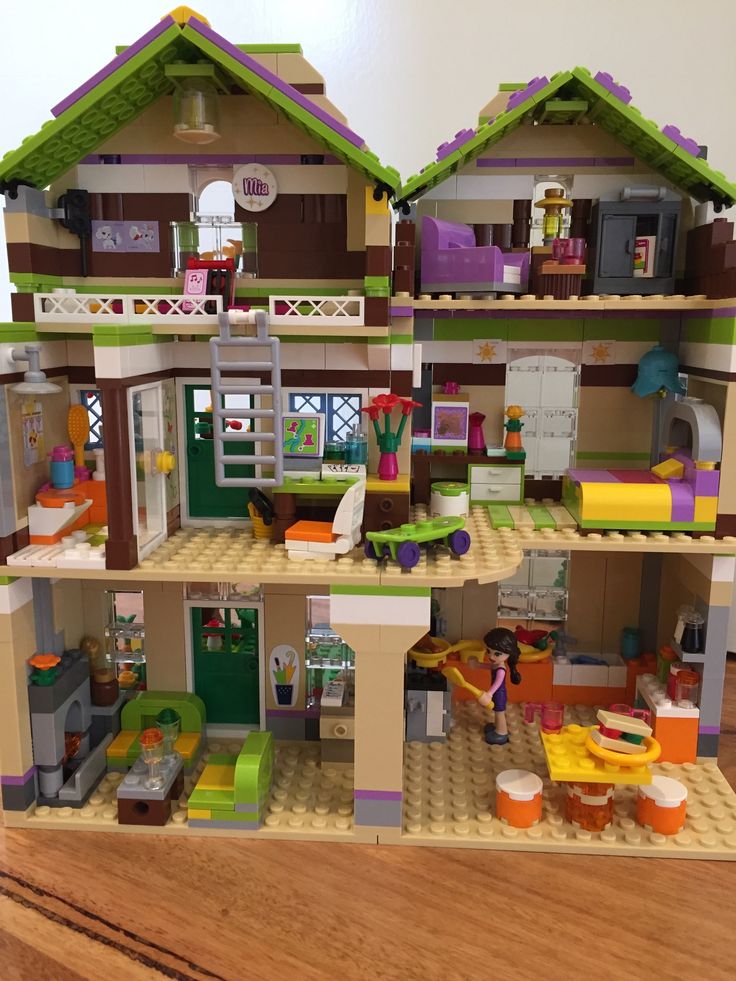 a lego house is shown on a wooden floor