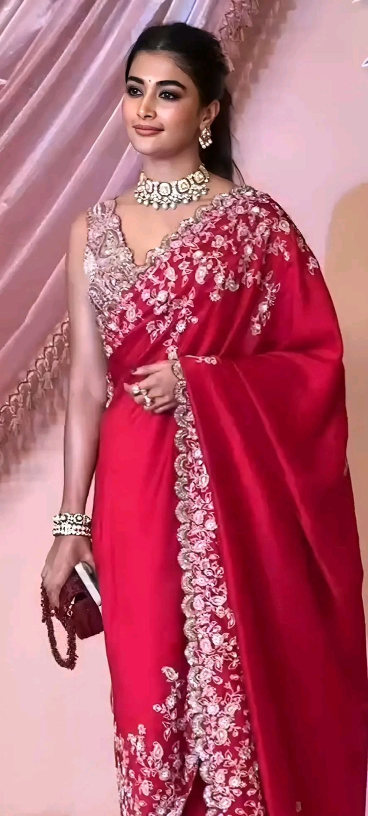 a woman in a red sari and matching jewelry