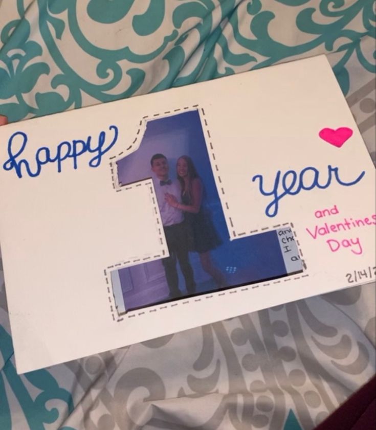 a birthday card with the number one on it and an image of a man and woman standing next to each other