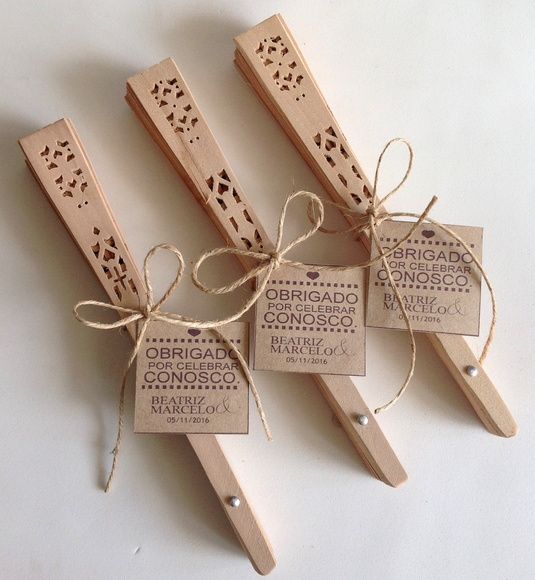 three wooden pegs tied with twine and labeled with the names of different countries