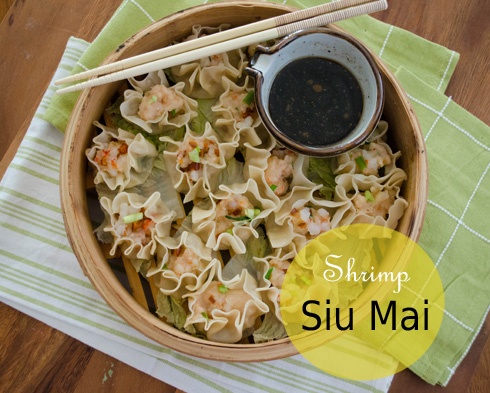 a bowl filled with shrimp and noodles next to chopsticks on top of a table