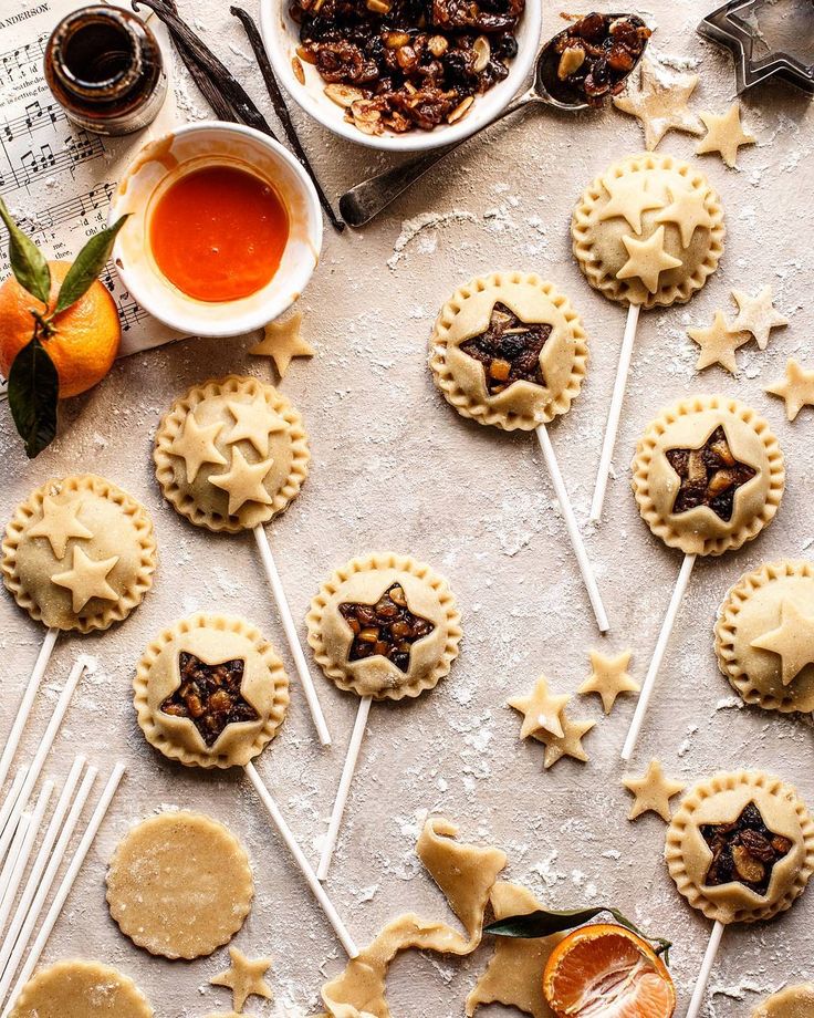 cookies and candies are arranged on a table with utensils for desserts