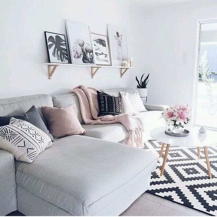 a living room filled with lots of furniture and pictures on the wall above it's coffee table