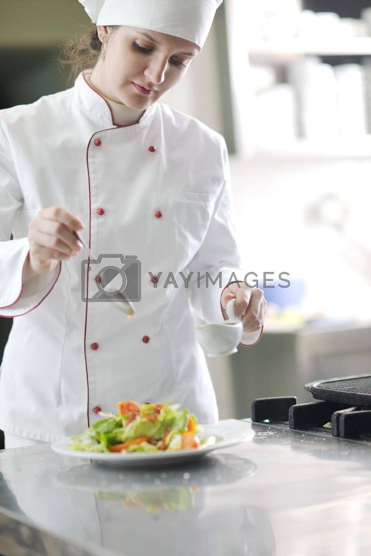 a female chef preparing food on a plate