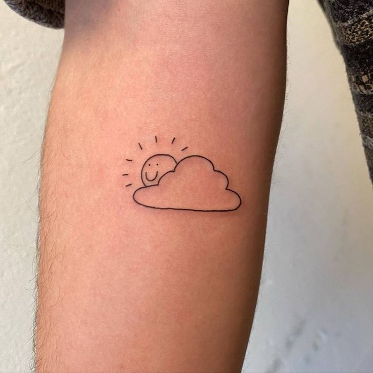 a small sun and cloud tattoo on the right arm, it looks like an outline