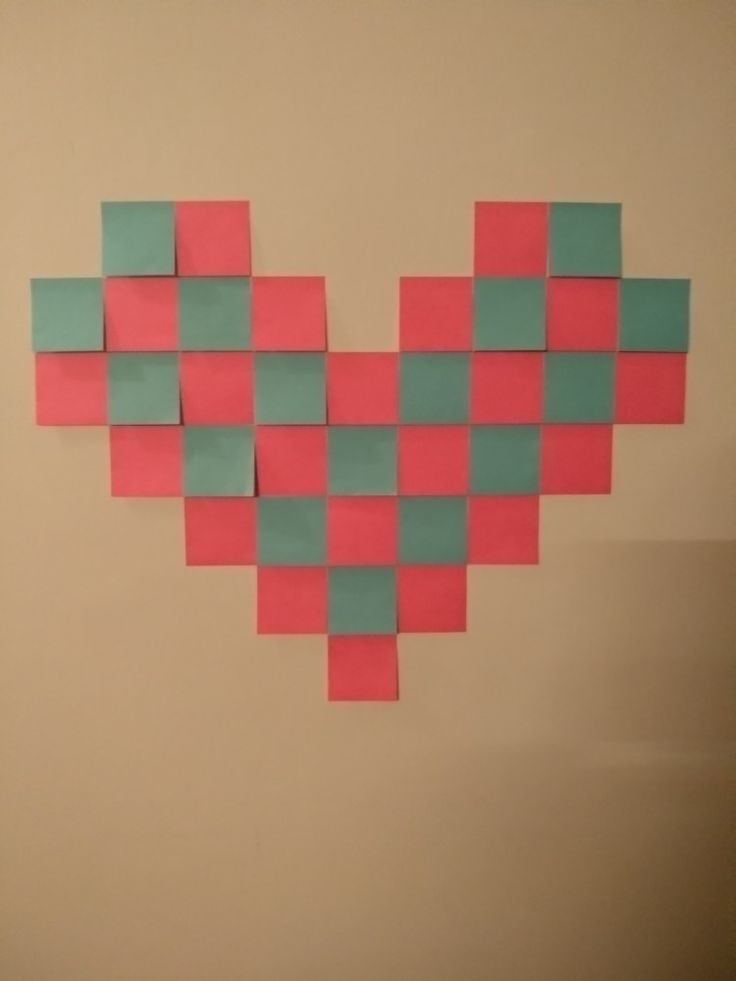 a heart made out of colored squares on a wall