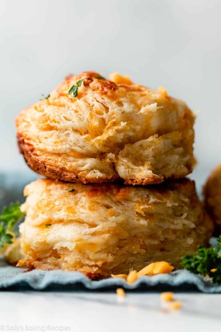 two crab cakes stacked on top of each other with parmesan cheese and herbs