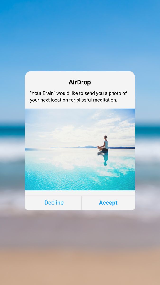 an airdrop app on the beach with someone sitting in the water and looking out at the ocean