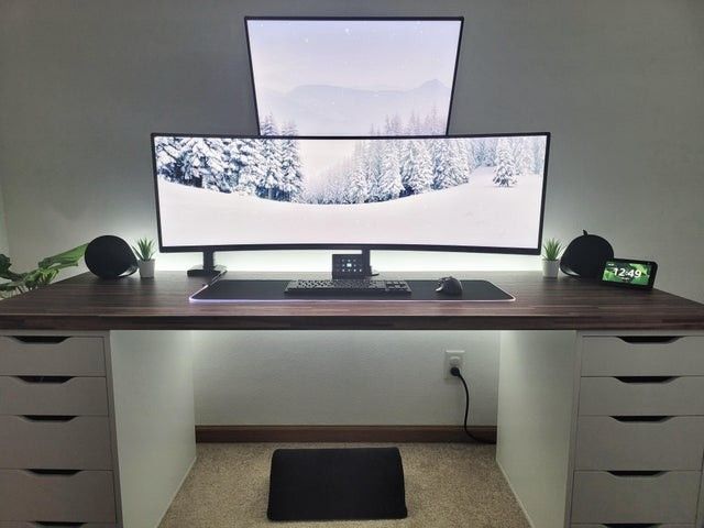 a desk with a computer monitor and keyboard on it