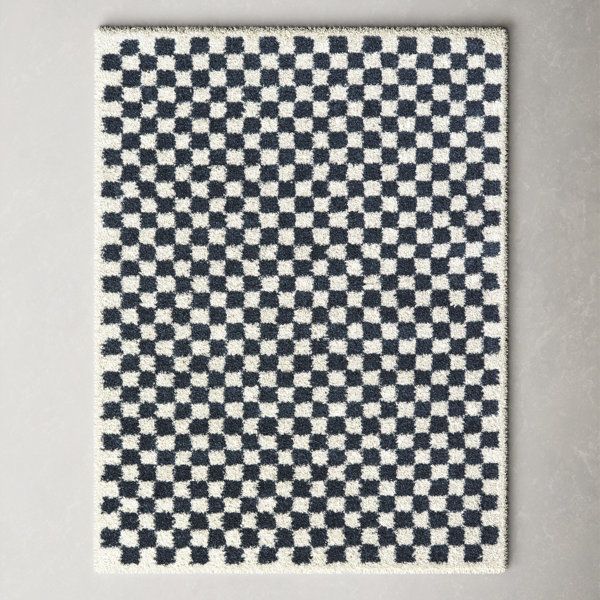 a black and white checkered rug on a wall