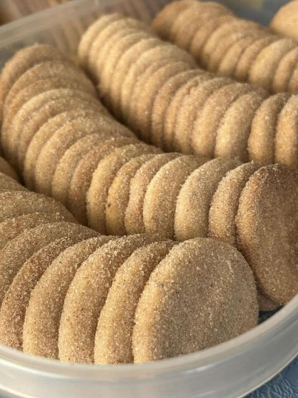 a plastic container filled with cookies on top of a table