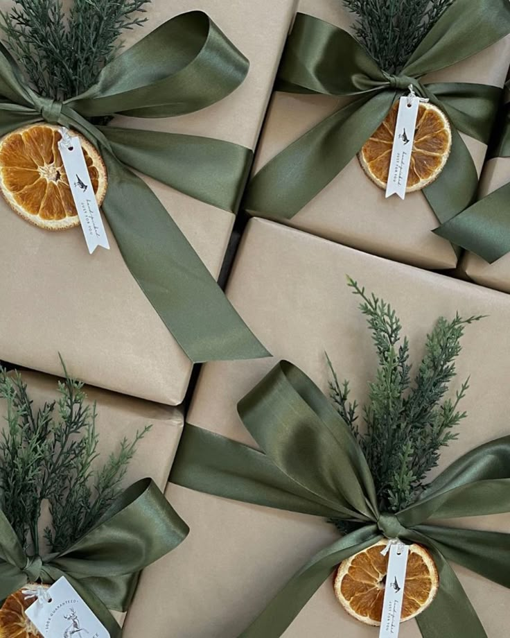 several wrapped presents with orange slices and green ribbons