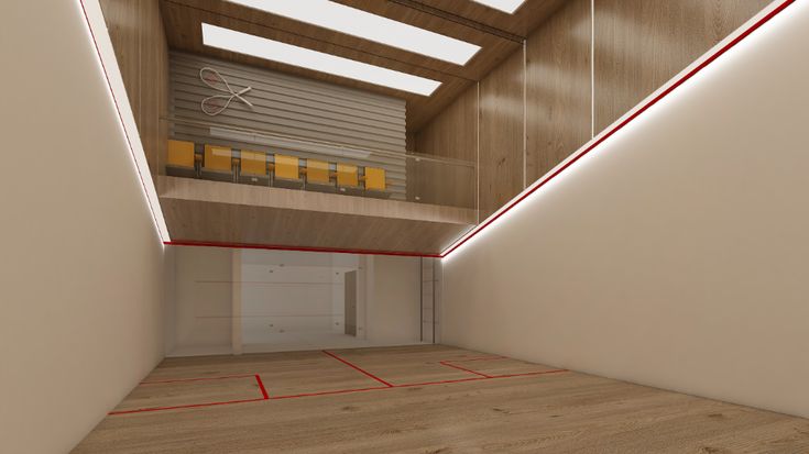 an empty basketball court with red lines on the floor and yellow bars in the wall