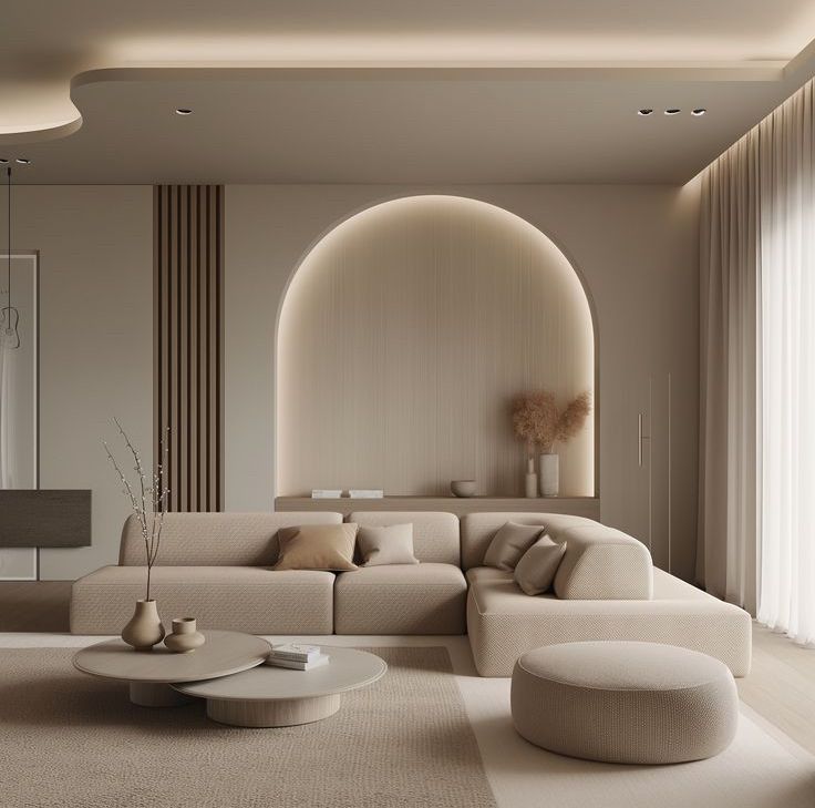 a modern living room with white furniture and beige walls, along with a large arched window