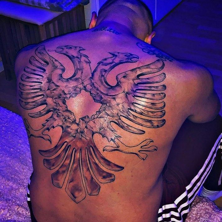 a man with a tattoo on his back