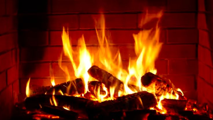 a fire burning in a fireplace with bright flames