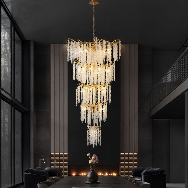 a large chandelier hanging from the ceiling in a room with black walls and chairs