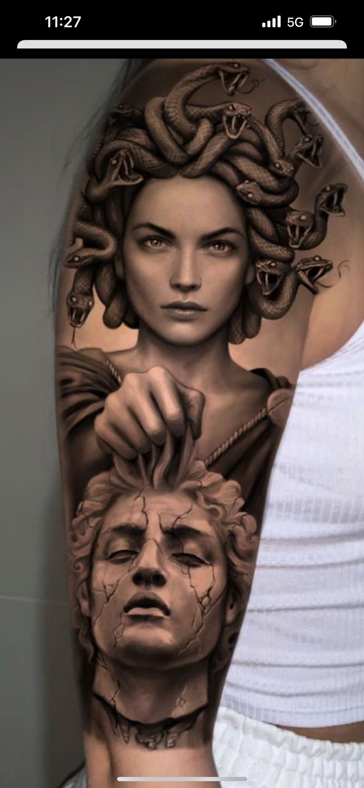 a woman's arm with tattoos on it and an image of a man holding a snake