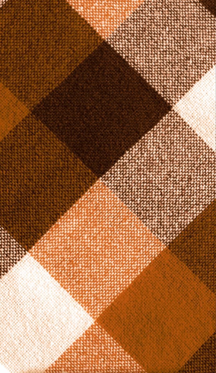 an orange and brown checkered fabric textured with some sort of clothing material