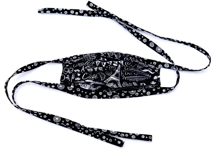 a black and white face mask with skulls on it