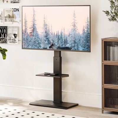 a flat screen tv sitting on top of a stand in front of a book shelf