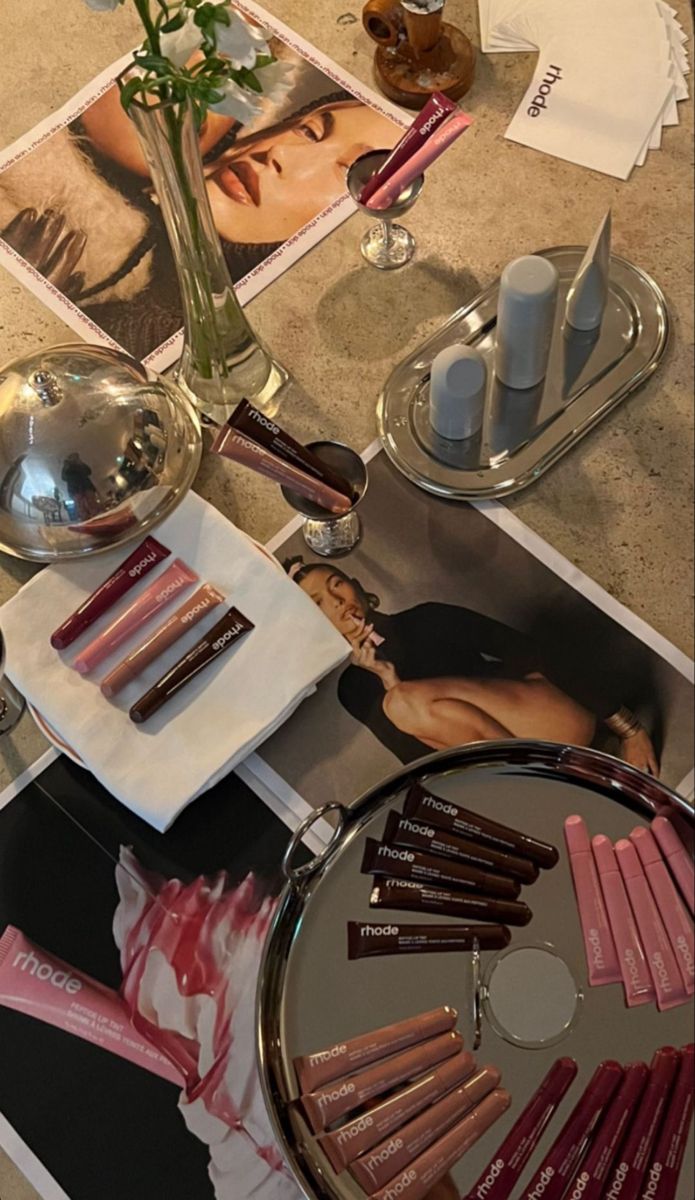 a table topped with lots of lipstick and makeup products