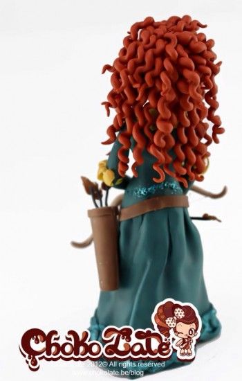 a doll with red hair is holding a flower pot