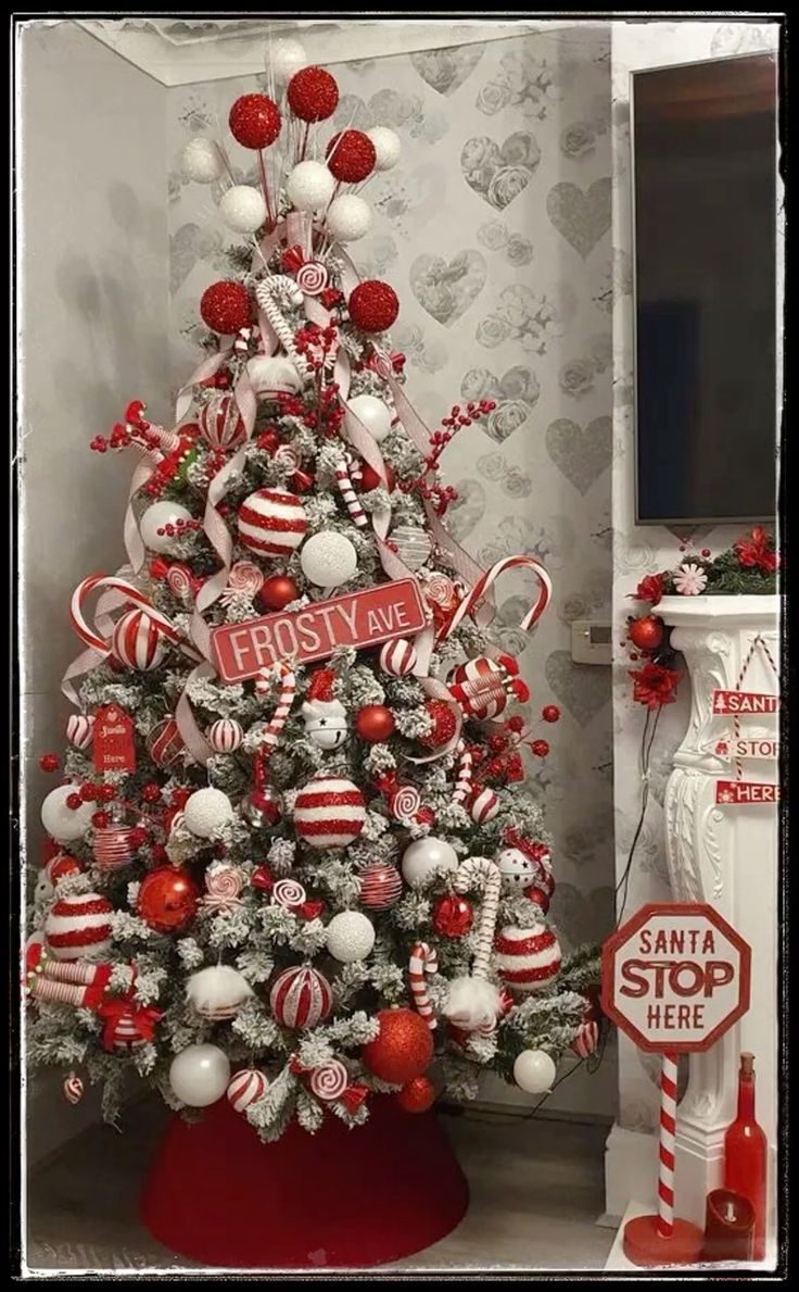 a christmas tree decorated with candy canes and candies in red, white and silver