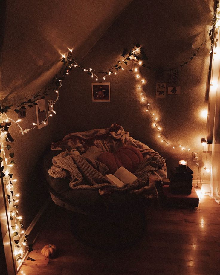 a room with lights and blankets on the floor