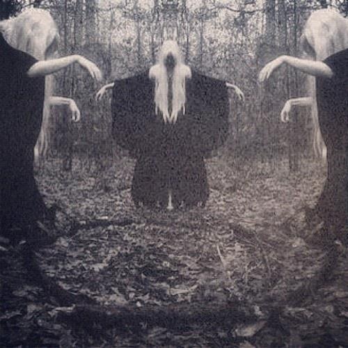 three ghostly people standing in the woods with their hands out to touch each other's heads