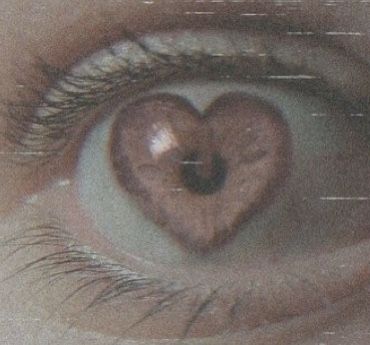 an eye with the reflection of a heart in it's irise, as seen from above