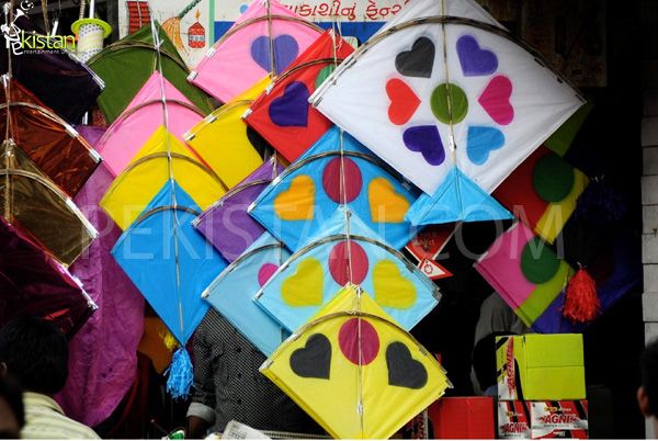 many colorful kites are hanging on the wall