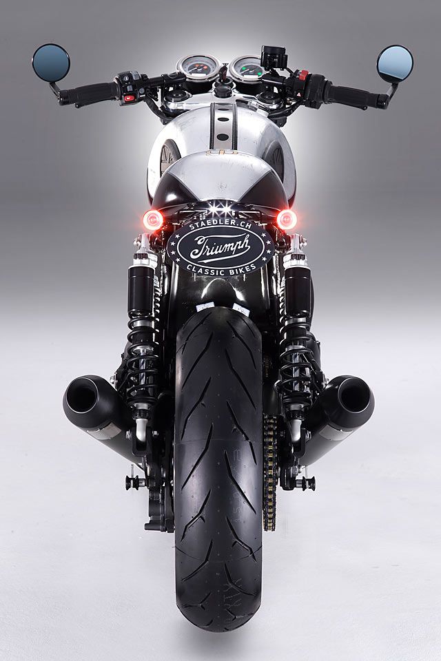 the front end of a motorcycle with its lights on