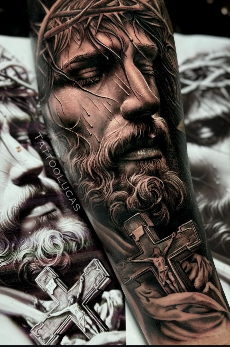 a man's arm with a cross and jesus on it, in black and grey