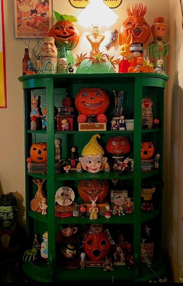 a green shelf filled with lots of halloween decorations