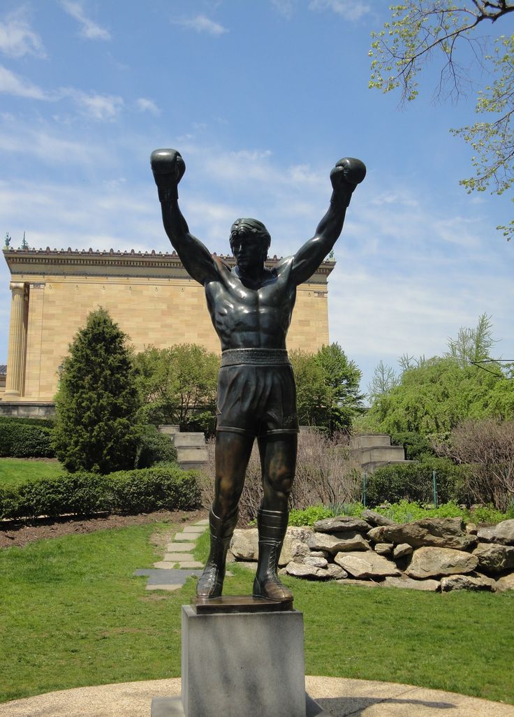 a statue of a man with his arms in the air