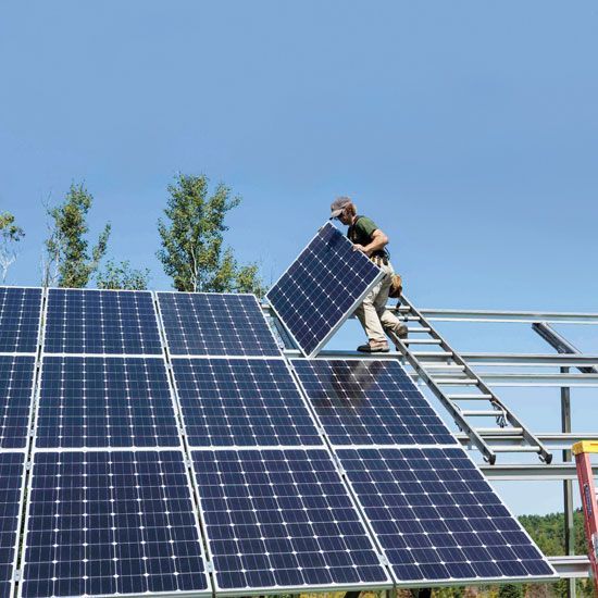 a man is working on a solar panel